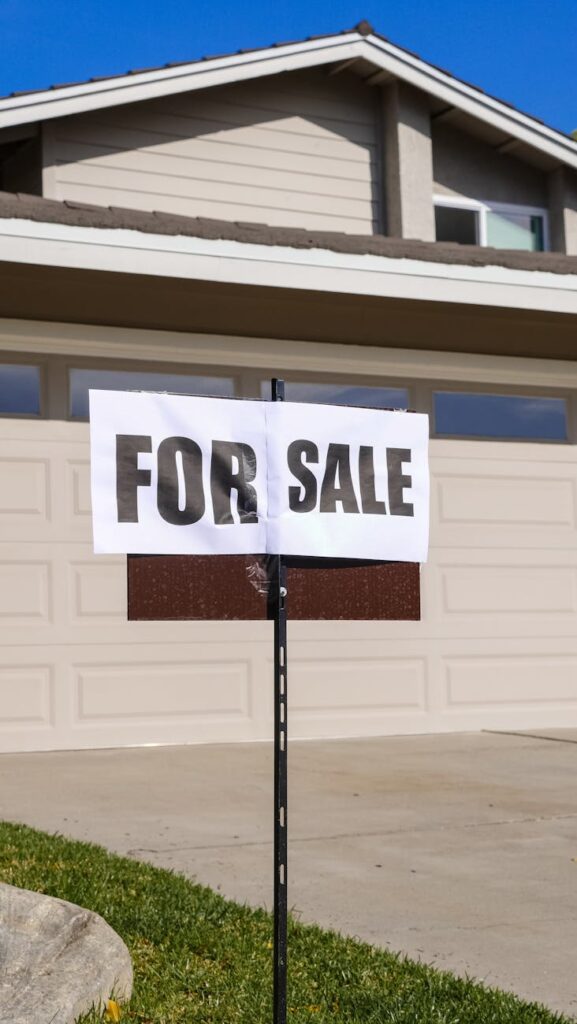 for sale sign in front of a house